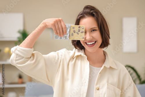 Happy young woman holding w...