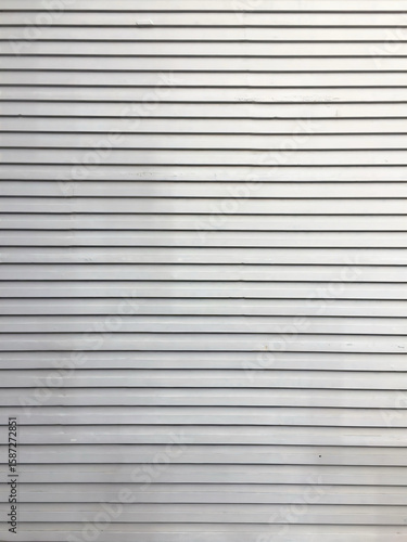 Wallpaper Mural Minimalist horizontal metal shutter texture in silver color, perfect for industrial, architectural, or urban design backgrounds. Torontodigital.ca