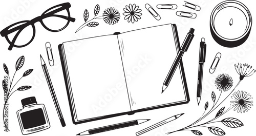 Open notebook with pens pencils inkwell glasses candle and floral elements open book
