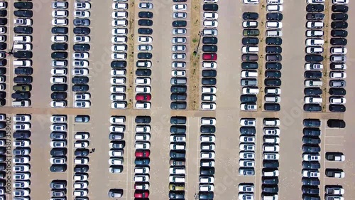 Straight rows of new cars in the factory parking lot