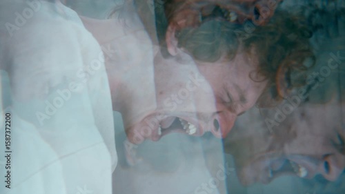 Overwhelmed male patient screaming in anguish during mental breakdown in psychiatric hospital ward. Kaleidoscope effect