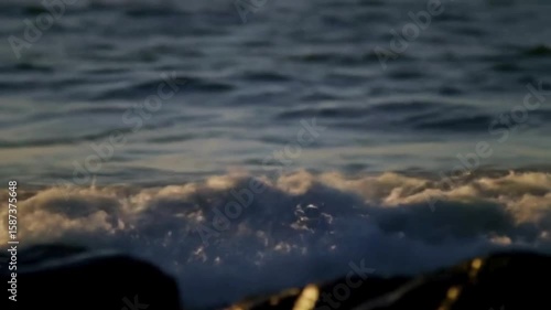 Waves Crashing on Rocks at Sunset – Serene Ocean Scene

