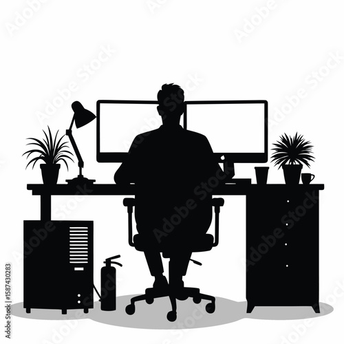 Person working at desk with dual monitors and computer equipment silhouette