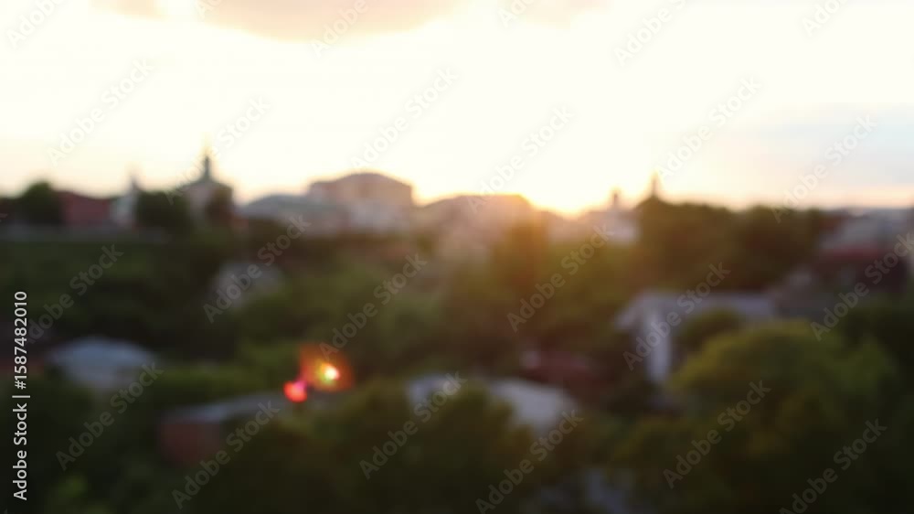 Sunset over Vladimir historic town with domes and rooftops surrounded by lush green trees. Scenic cityscape at golden hour featuring bell towers, churches and summer foliage. Sunset over Vladimir historic town with domes and rooftops surrounded by lush green trees. Scenic cityscape at golden hour featuring bell towers, churches and summer foliage.