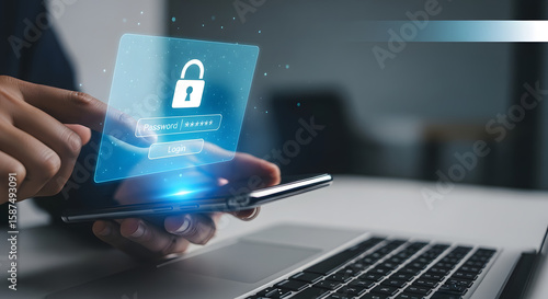 Person using smartphone for online security access with password and padlock icon.  Hands hold phone above laptop keyboard.