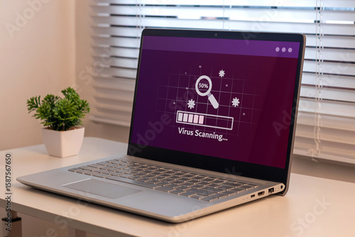 A laptop on the table with virus scanning process. Anti virus and bug protection technology concept.