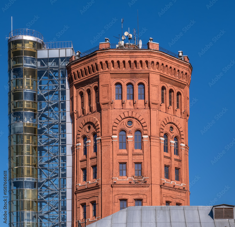 Fototapeta premium An old brick water tower against the sky.