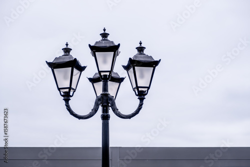 An antique pillar with lamps on a white background.