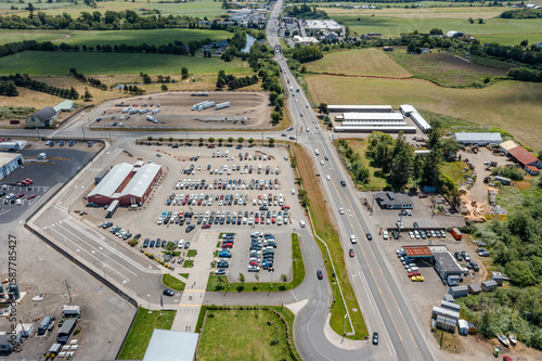 Fotografie Aerial drone top-down view of a busy and full parking lot at a large dairy facto