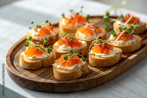 Gourmet appetizer platter featuring crostini topped with cream cheese and salmon roe