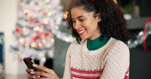 Fotografija Christmas, woman and typing with phone in home for holiday text, season greeting and chat