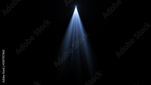 A single spotlight shines brightly downwards, illuminating a dark space, creating a visual focus.