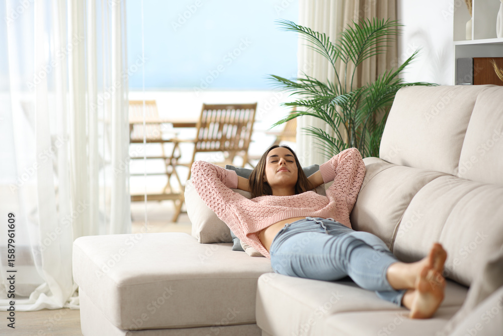 Woman sleeping lying on a couch in the living room at home Woman sleeping lying on a couch in the living room at home