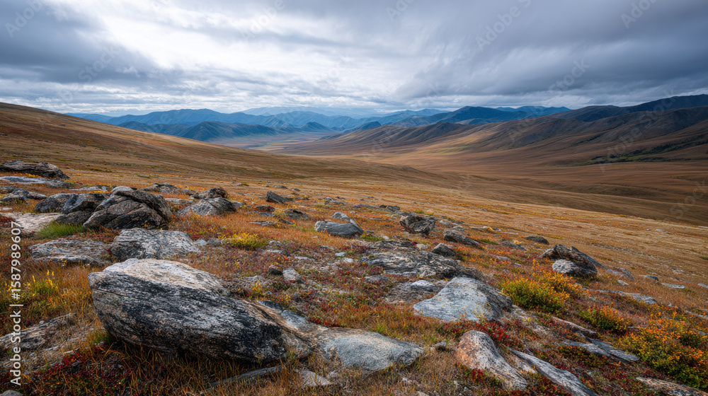 Fototapeta premium Vast landscape with rocky terrain, rolling hills, and dramatic clouds. scene evokes sense of tranquility and natural beauty