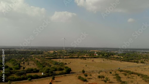 Expansive landscape with wind turbines under a cloudy sky