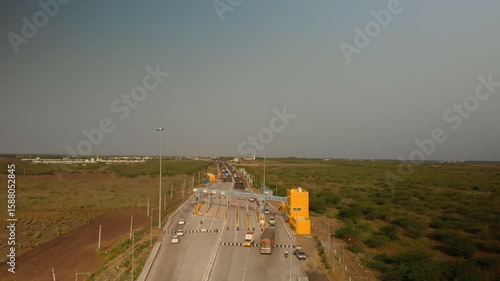 Busy toll road on a clear day with vehicles in motion