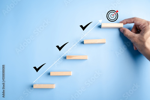 Fotografie Business growth success and achievement with hand arranging wooden steps and check marks, goal setting, progress tracking, and personal development