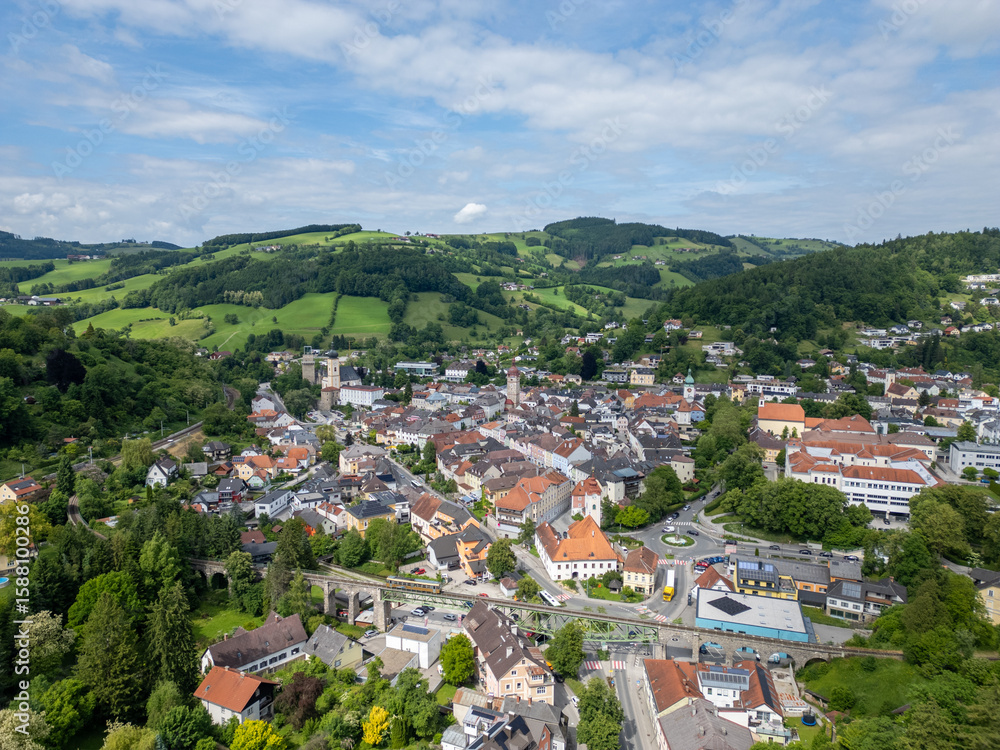 Fototapeta premium Waidhofen an der Ybbs town aerial view with lush green hills and historic architecture in Lower Austria, summer landscape