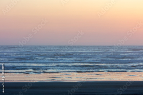 Ocean waves and beach at dusk