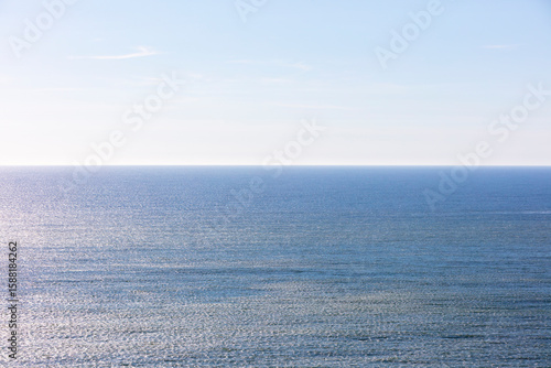 The blue ocean and sky, calm water.