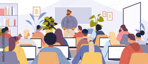 Classroom teacher students learning modern education diverse group using laptops plants bookshelves interior academic lesson