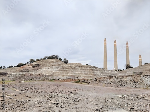 Industrial Landscape with Power Plant Smokestacks and an Open-Pit Mine