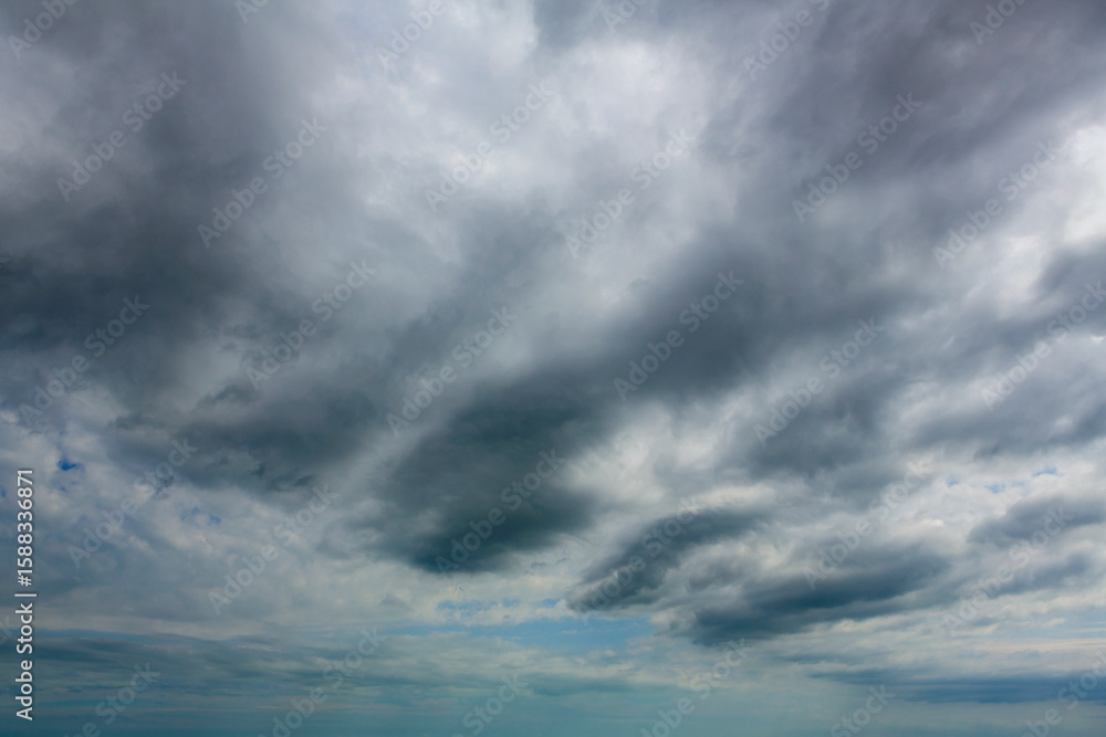 Fototapeta premium Beautiful background of a stormy sky - the sky at sunset and sunrise with gloomy clouds