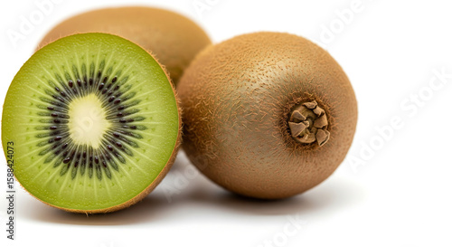 A halved kiwi fruit next to two whole kiwis isolated on a white background