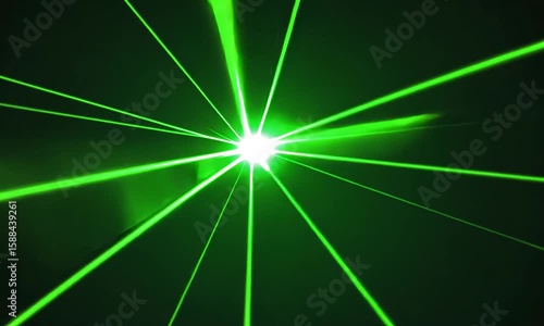 Bright green laser beams radiating outward from a central point on a black background