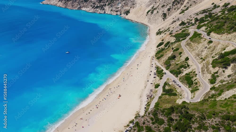 Aerial view of Vibrant turquoise sea meets sand, rugged cliffs, summer travel in Kefalonia, Greece Aerial view of Vibrant turquoise sea meets sand, rugged cliffs, summer travel in Kefalonia, Greece