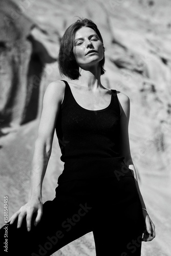 A stunning monochrome portrait of a woman with sunlight casting shadows.