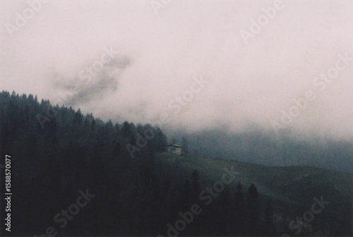 Ancient Italian Stone Mountain House at the Edge of the Forest during a Spring Cloudy Day. Bergamo Alps, Italy. Film Photography