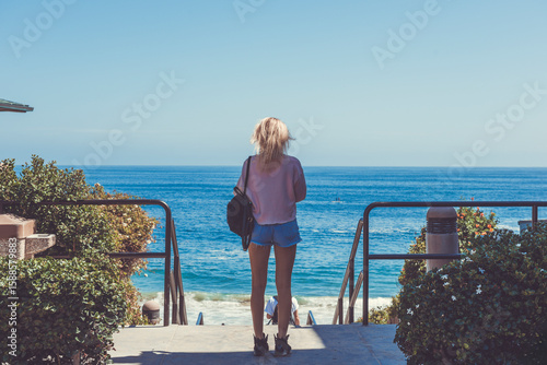 Young Woman Relaxing at Summer Sky Outdoor in a front of Pacific Ocean. Laguna Beach. California. USA