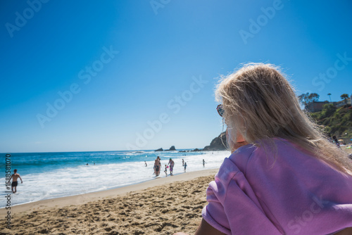 Young Woman Relaxing at Summer Sky Outdoor in a front of Pacific Ocean. Laguna Beach. California. USA