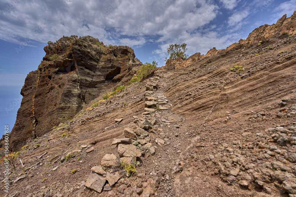 Fototapeta premium Volcanic cliff with ancient trail steps