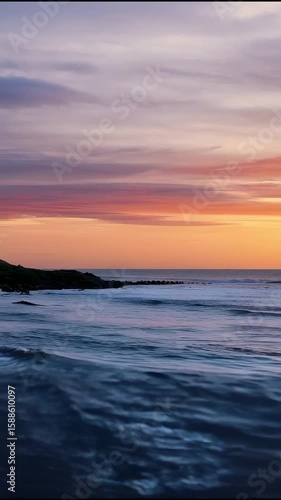 Serene Sunset Over the Ocean: A Calm and Peaceful Coastal Scene with Gentle Waves Reflecting Warm Hues of the Sky