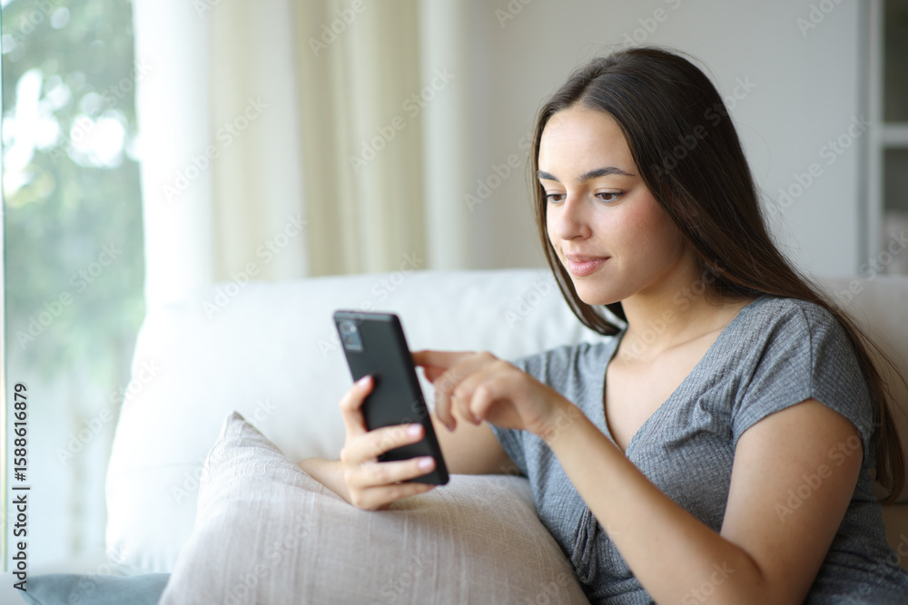 Woman checking online content on mobile phone Woman checking online content on mobile phone