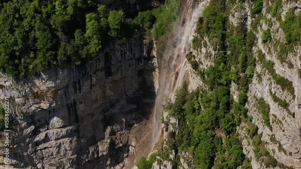 Seerenbachfälle, one of the tallest waterfalls in Switzerland, aerial view, surrounded by lush forest and steep cliff walls. Seerenbachfälle, one of the tallest waterfalls in Switzerland, aerial view, surrounded by lush forest and steep cliff walls.