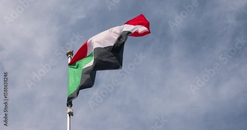 The flag of Sudan is captured in close-up. The flag of Sudan fluttering against the blue sky is the national symbol of Sudan. Great for news. The video is presented in 4K format.