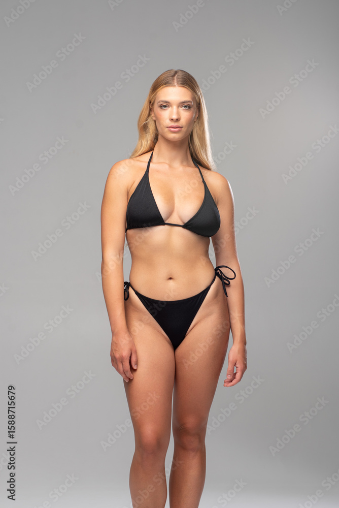 Fototapeta premium Studio model digitals of blonde female in black lingerie showing natural poses and physique for model agency