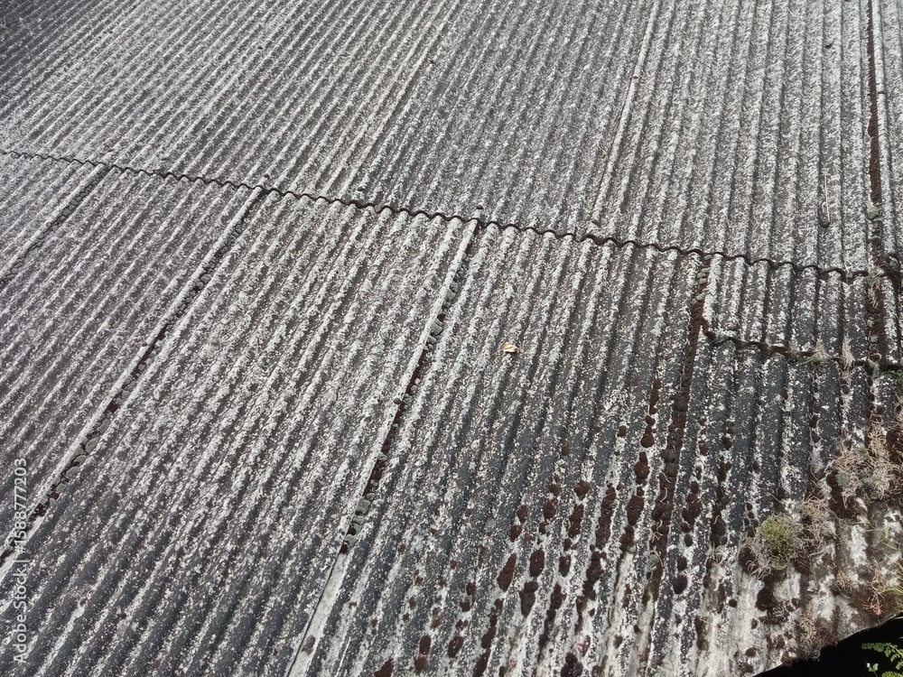 Fototapeta premium Old asbestos cement roofing sheets with rainwater drainage, asbestos roof, corrugated asbestos cement roof sheet, corrugated panels