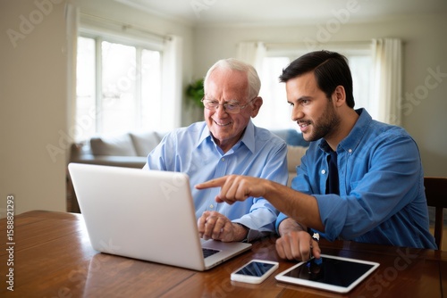 Multigenerational Learning Young Man Teaching Senior Citizen How to Use Computer Technology