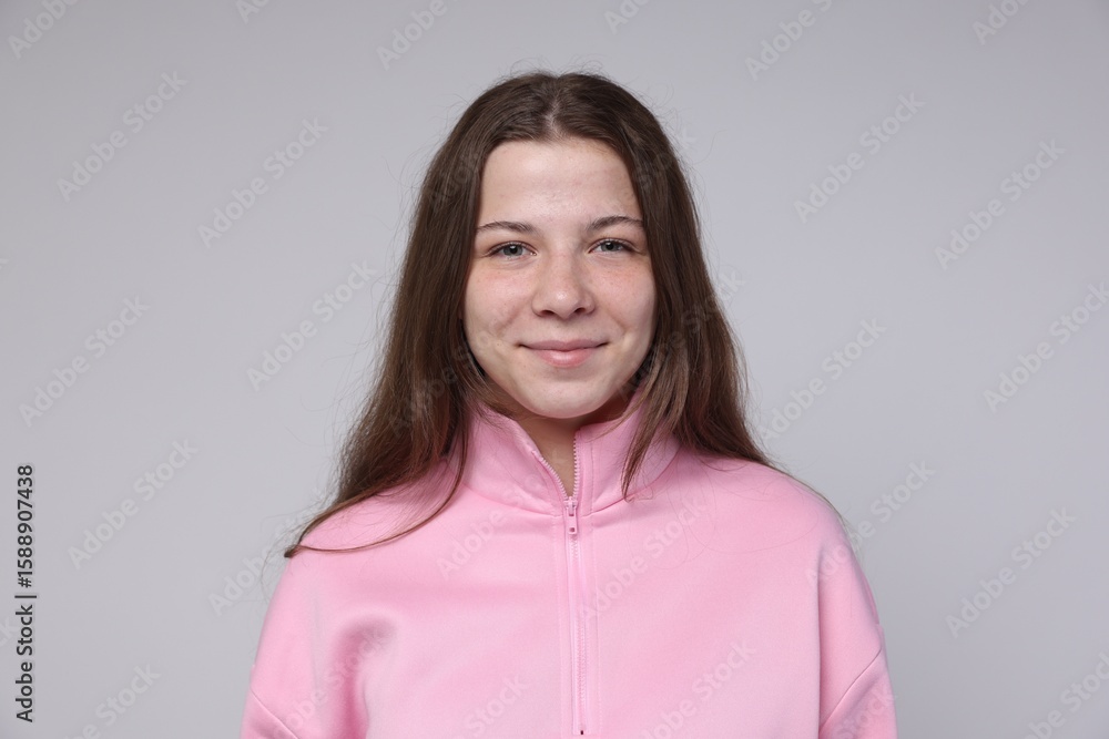 Obraz premium Portrait of teenage girl on light grey background