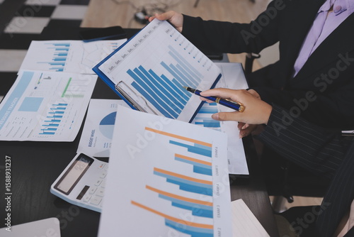 Team of business people working together in the meeting room office,
teamwork background charts and graphs banner, double exposure successful teamwork,business planning concept.