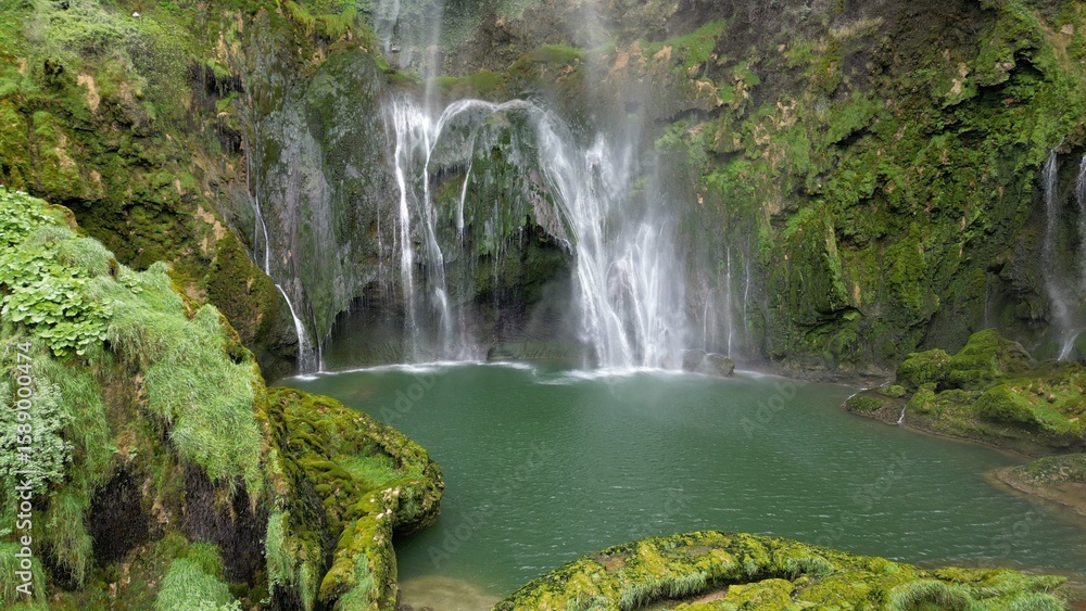 Fototapeta premium Italy, Umbria, Spectacular drone view of the Marmore Falls with water falling from above in a natural setting of unique beauty with pools of green water immersed in the lush nature