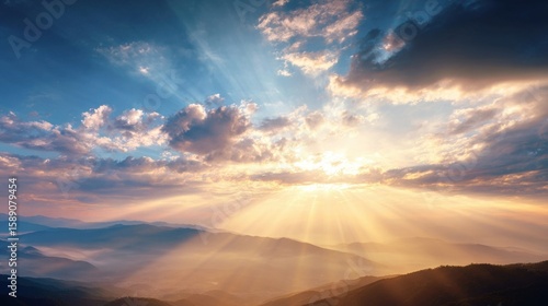 Stunning sunrise over mountains with vibrant clouds and golden sunlight beams.