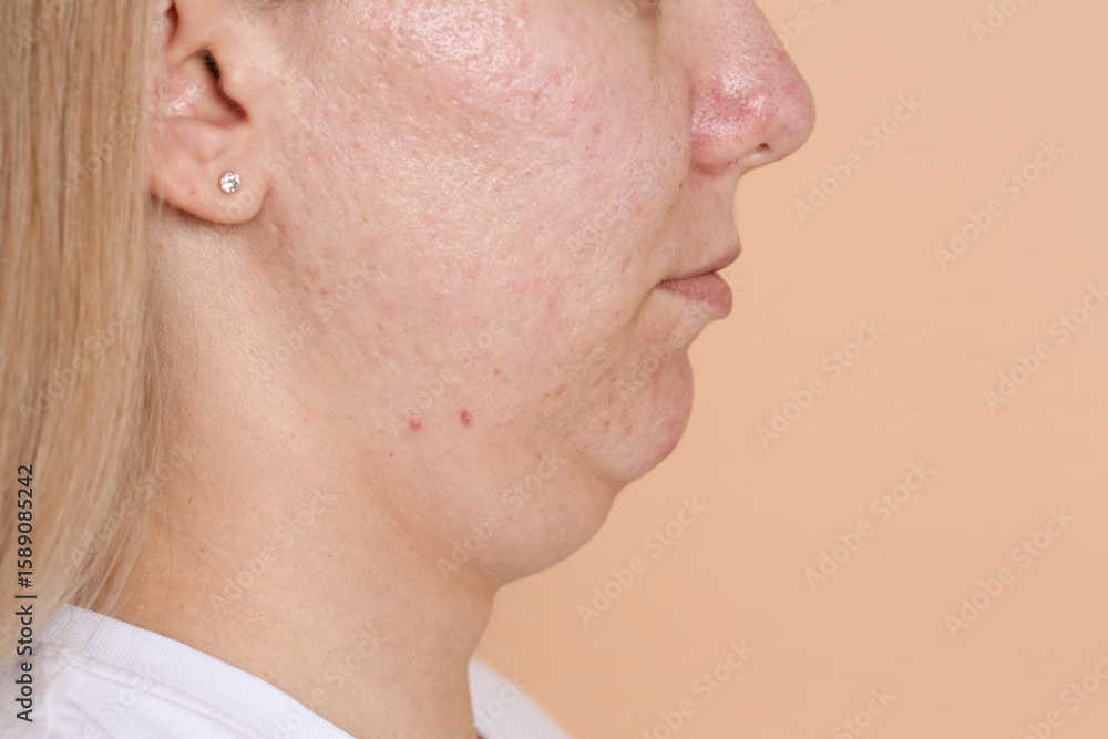 Fototapeta premium Woman with double chin on beige background, closeup. Space for text