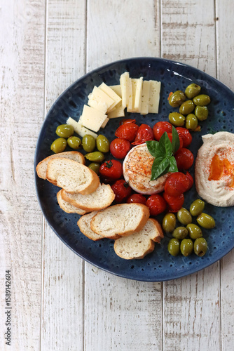 Italian antipasti with tomatoes, olives and cheese
