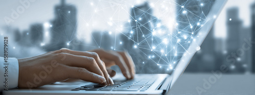 Person types on laptop with futuristic connection overlay. Use for technology, web design, or marketing.
