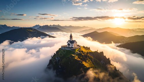 Aerial View of Church on Mountaintop Above Clouds at Sunrise